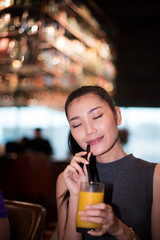 Working Asian Woman Black hair having Lunch Dinner of vegetable fruit Juice glass Western food in fusion restaurant cafe and eat alone. Concept enjoy eating myself for good food life