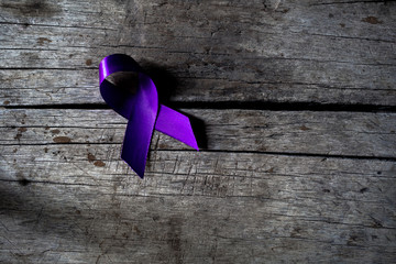 a purple ribbon for the awareness about the unacceptability of the violence against women, on a...