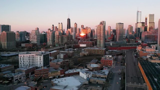 Late Sunset reflecrs on buildings and streets of the downtown urban core of Chicago Illinois