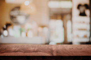 Empty wood table with blur cafe background.