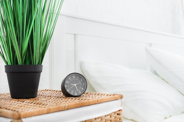 Fototapeta na wymiar Alarm clock near the bed at home. Good morning concept.