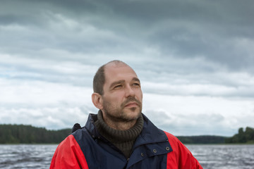 Conceptual Portrait Of A Bearded Man Against A Overcast Sky