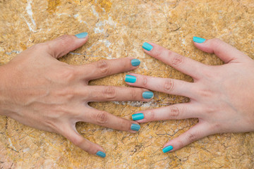 Woman hand touch on the stone