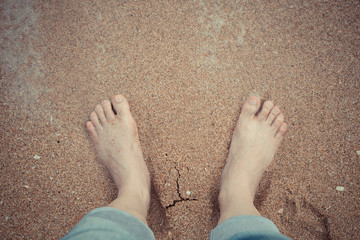 Relaxing at a beach, with your feet in the wet sand