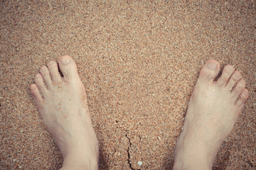 Relaxing at a beach, with your feet in the wet sand