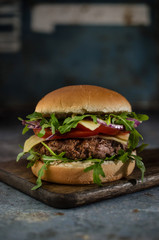  Tasty beef burger with vegetables on the table