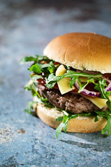  Tasty beef burger with vegetables on the table