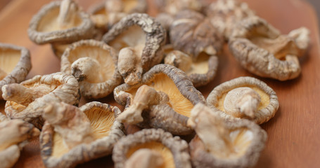 Stack of dry mushroom on wooden plate