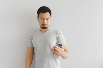 Man feels hate and disgusted with what show on the smartphone.