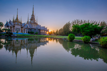 Wallpaper Wat Lan Boon Mahawihan Somdet Phra Buddhacharn(Wat Non Kum)is the beauty of the church that reflects the surface of the water, popular tourists come to make merit and take a public photo 