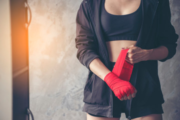 Boxing Woman prepare to trianing session and kickboxing,workout at thai boxing gym.Fit Female...