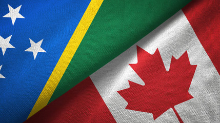 Fototapeta premium Solomon Island and Canada two flags textile cloth, fabric texture 