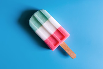 Flat lay of colorful ice cream on the modern rustic on blue background at home office desk wallpaper, top view colorful ice cream pattern on blue pastel background. Minimal summer concept...