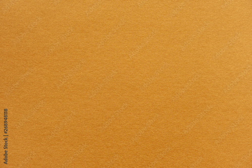 Wall mural abstract yellow glossy paper texture background or backdrop. empty wrapping paper or shiny paperboar