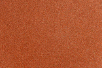 Abstract orange glitter paper texture background or backdrop. Empty shimmer paper or shiny...