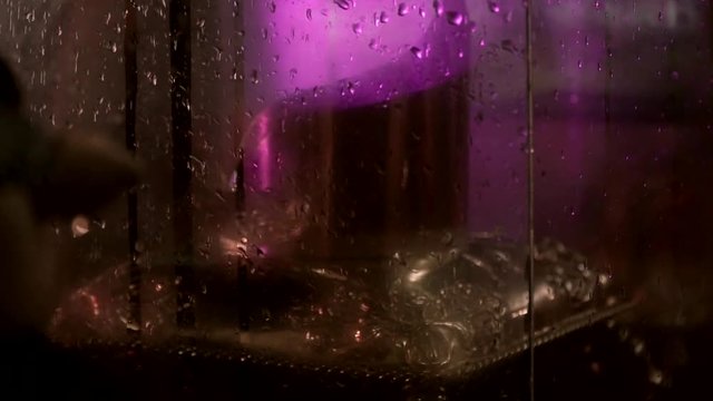 Rain Drops on the Glass in the night purple light on the background stock footage