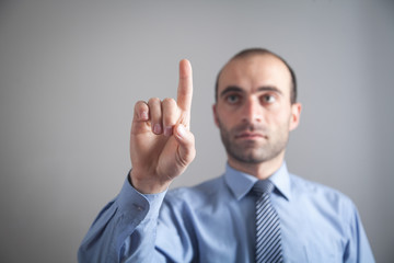 Businessman pointing or touching finger in screen.