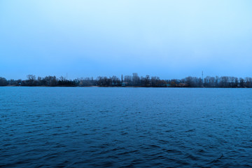 Beautiful view of the water in the river and sky. Cold evening.