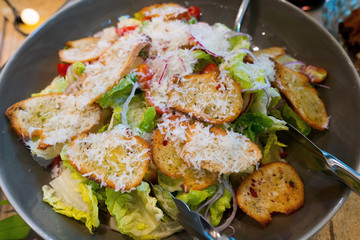 Classic Caesar Salad with vegetable cheese bread mix on bowl, American Style BBQ grill on natural charcoal to make good smell