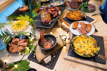 Mix Various Smoked steak Ham Pork in American Style, salad, hot spicy Foods on table atmosphere, Smoke steaks Hams Porks in USA BBQ grill on natural charcoal to make good smell