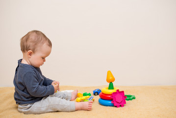 Adorable baby playing with educational toys . background with copy space. Happy healthy child having fun at home. Early development for children.