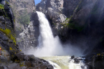 Altai waterfall in rocks on a sunny summer day.