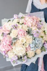 Large Beautiful bouquet of mixed flowers in woman hand. Floral shop concept . Beautiful fresh cut bouquet. Flowers delivery