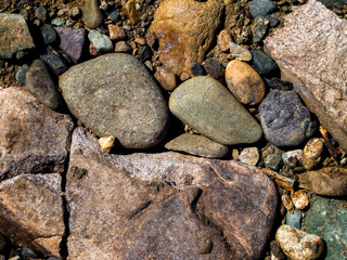 Fototapeta na wymiar Stones on the ground. Rock background. Ground and stones. Rocky soil. Stone background. Natural