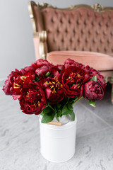 Red peonies in a metal vase. Beautiful peony flower for catalog or online store. Floral shop concept . Beautiful fresh cut bouquet. Flowers delivery