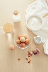 Fototapeta na wymiar recipe ingredients : eggs, flour, milk, almonds, banana on white background