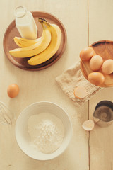 Ingredients and tools for baking sweet cake with banana and almonds