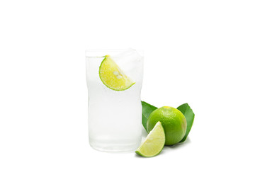 Glass of sparkling water soda with ice and lime slice on white background.