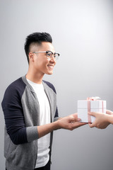 Young asian man receiving gifts box from his colleague over white background