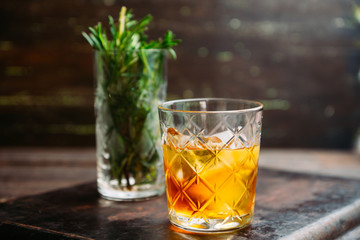 Old fahioned cocktail on the rustic background. Selective focus. Shallow depth of field.