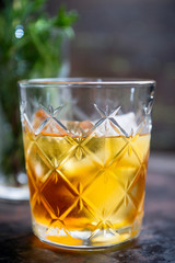 Old fahioned cocktail on the rustic background. Selective focus. Shallow depth of field.