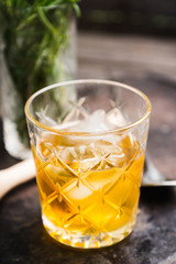 Old fahioned cocktail on the rustic background. Selective focus. Shallow depth of field.
