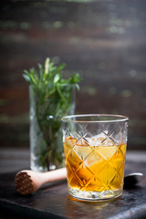 Old fahioned cocktail on the rustic background. Selective focus. Shallow depth of field.