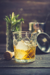 Old fahioned cocktail on the rustic background. Selective focus. Shallow depth of field.