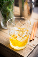 Old fahioned cocktail on the rustic background. Selective focus. Shallow depth of field.