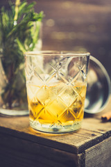 Old fahioned cocktail on the rustic background. Selective focus. Shallow depth of field.