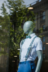 mannequins with modern clothes in fashion store display window 
