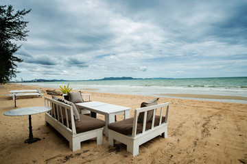 white table set on the cloudy day beach