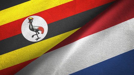 Fototapeta premium Uganda and Netherlands two flags textile cloth, fabric texture