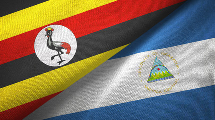 Fototapeta premium Uganda and Nicaragua two flags textile cloth, fabric texture