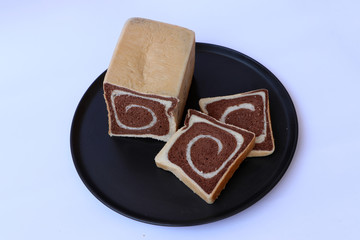Two tone bread chocolate in the black round plate.