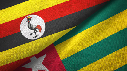 Fototapeta premium Uganda and Togo two flags textile cloth, fabric texture