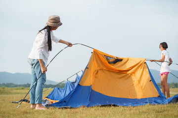 Asian families with mothers and children Traveling to relax, being a tent for relaxation, The...