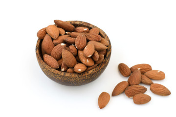 Almond nuts in a brown bowl on a white background
