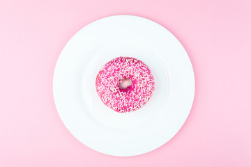 Pink round donut at bright pink background