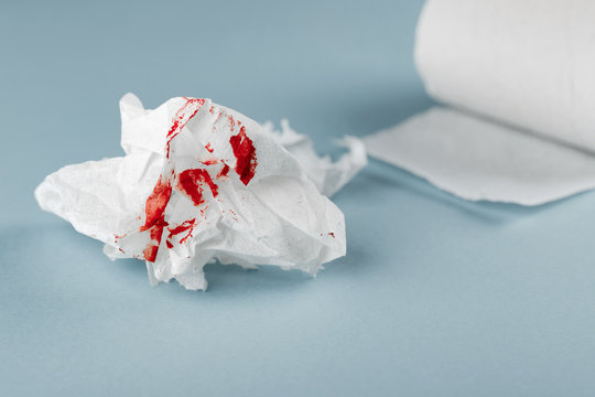 Blood on tissue paper on white background. Health medical concept.